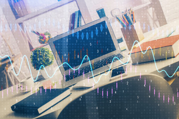Double exposure of chart and financial info and work space with computer background. Concept of...