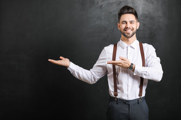 Male teacher near blackboard in classroom