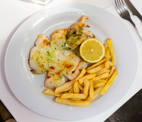 Delicious grilled cuttlefish on plate, served with french fries