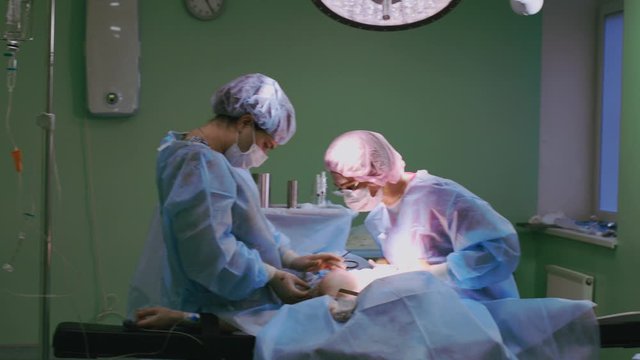 Modern medetsina, a team of surgeons makes an operation. Modern medical equipment allows surgeons to perform delicate and precise operations. Fight against oncology
