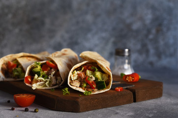 Burrito - mexican dish with corn tortilla, jasse, vegetables and sauce. Tortilla stuffed.
