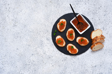 Toast bread with red caviar. Sandwich with caviar and butter on a concrete background.
