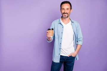 Portrait of charming positive man have weekends hold cup with hot beverage espresso feel content emotions wear good looking outfit isolated over violet color background