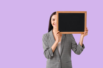 Female teacher with chalkboard on color background