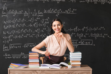 Female teacher at workplace in classroom