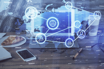 Computer on desktop with social network theme icon. Multi exposure. Concept of international connections.