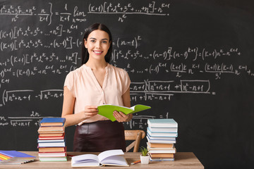 Female teacher at workplace in classroom