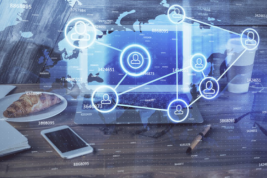 Computer on desktop with social network theme icon. Multi exposure. Concept of international connections.