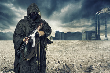 A lonely post apocalyptic survivor in mask wanders through the wasteland.