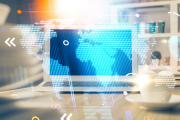 Multi exposure of table with computer and world map hologram. International data network concept.