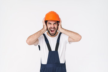Stressful young man builder in helmet
