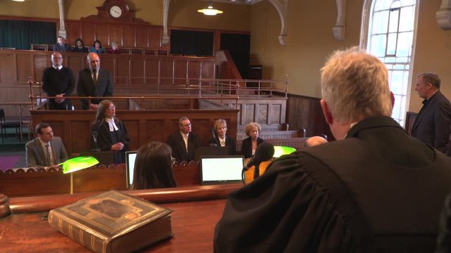 4K: Court / Courtroom trial taking place. Witness is being questioned. Wide Shot from behind the Judge. 
