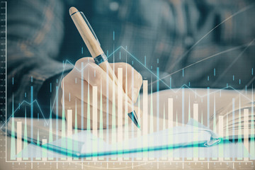 Multi exposure of woman's hands making notes with forex graph hologram. Concept of technical...