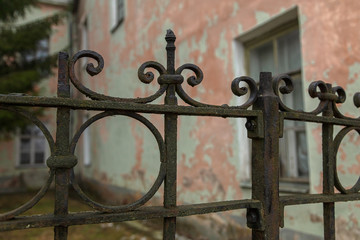 Wrought iron old fence covered with moss. It's a nasty day . The effect of adding grain.