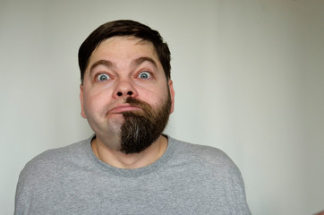 Bearded man, part of the face without a beard, shaved.