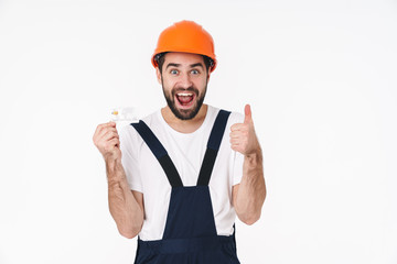 Emotional young man holding credit card.