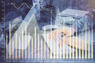 Double exposure of financial graph with man works in office on background. Concept of analysis.