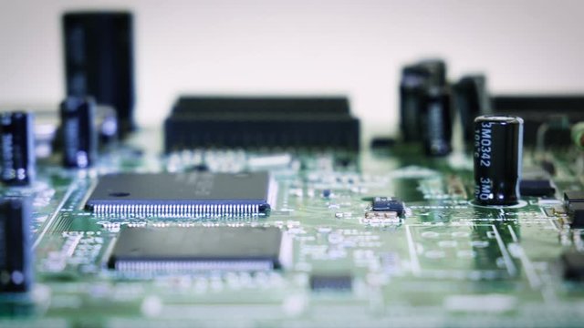 Close-up sliding shallow depth focus video of vintage pcb, electronic parts, IC. 4k