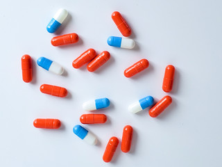 scattered capsules on a white background. Vitamins and Dietary Supplements.