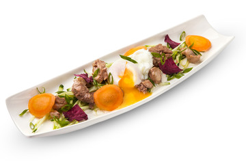 poached egg with tuna on an oblong white plate with vegetables. white background, isolated.
