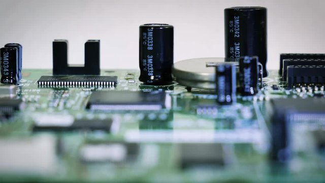 Close-up sliding video of printed circuit board - cap[acitors, resistors. 4k