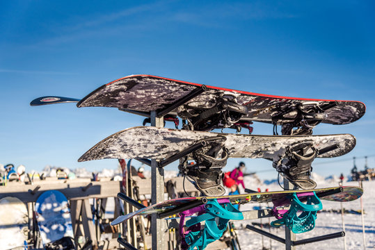 Snowboards on a snowboard's rac in the Alps. Snowboarding equipment.