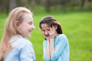 Fototapeta premium two funny confused little caucasian girls with grimace on face outdoor leisure