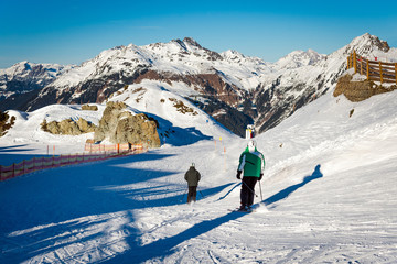 Skiers in the Austrian Alps. Winter sports recreation concept.
