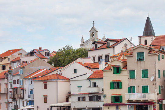 City view of traditional sea town in Croatia  with red tiled roofs and light  houses
