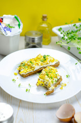 Healthy whole wheat bread with feta cheese, scrambled eggs and microgreens, proper nutrition sandwiches for breakfast