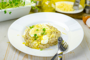 Oatmeal porridge with cheese and poached egg, healthy food for breakfast