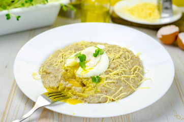 Oatmeal porridge with cheese and poached egg, healthy food for breakfast