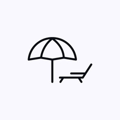 Chaise lounge under an umbrella
