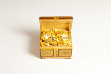 Opened single casket with golden foil as gold inside isolated on white with soft shadows, wooden box, wooden chest, treasure chest.