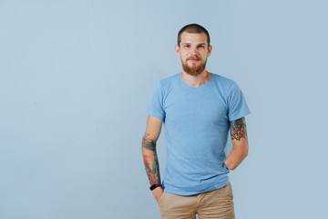 Happy relaxed bearded man without left hand feeling at home over blue background