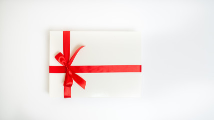 Gift box white with a red ribbon