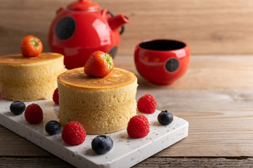 Trendy asian food, Fluffy homemade japanese souffle pancakes, hotcakes with raspberry, blackberry with copy space.