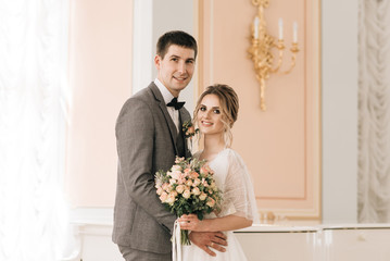 Beautiful elegant couple of newlyweds in love in a luxurious interior
