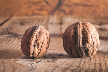 walnuts on a wooden table. Whole (in shell) and split and nut kernel.