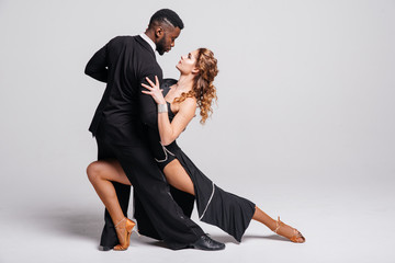 Couple dancers posing over white background. Dance school concept