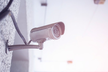 CCTV cameras are installed with poles in the parking lot. Security CCTV camera or surveillance system on the white wall.