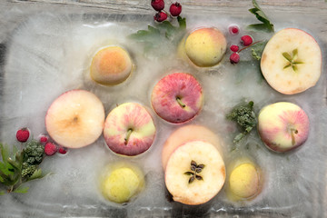 Background fresh season apple    frozen in ice