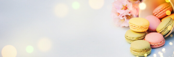 Obraz na płótnie Canvas Spring background with blossom and macaroon