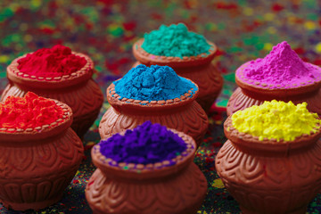 Fototapeta premium Indian Festival Holi, Colors in wooden bowl on dark background 