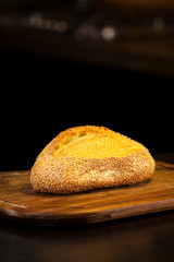 Sesame seed bread on wooden cutting board