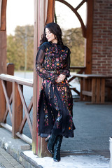 Fototapeta na wymiar Beautiful european woman posing in dress outdoor in winter