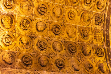 Detail of the sculptures of faces and roses of the vault of the Sacristia Mayor of the Cathedral of Siguencia, Aragon Spain