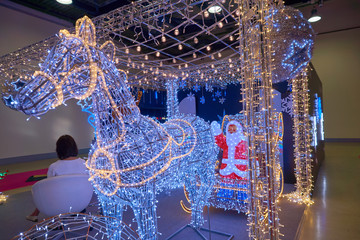 Illumination of Santa Claus in a cart on deer for Christmas