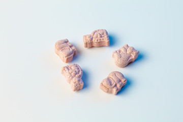 children's vitamins in the form of animals on a white background with light blue color