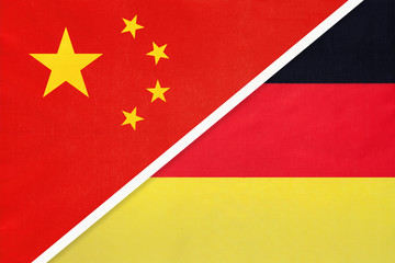 China or PRC vs Germany national flag from textile. Relationship between asian and european countries.